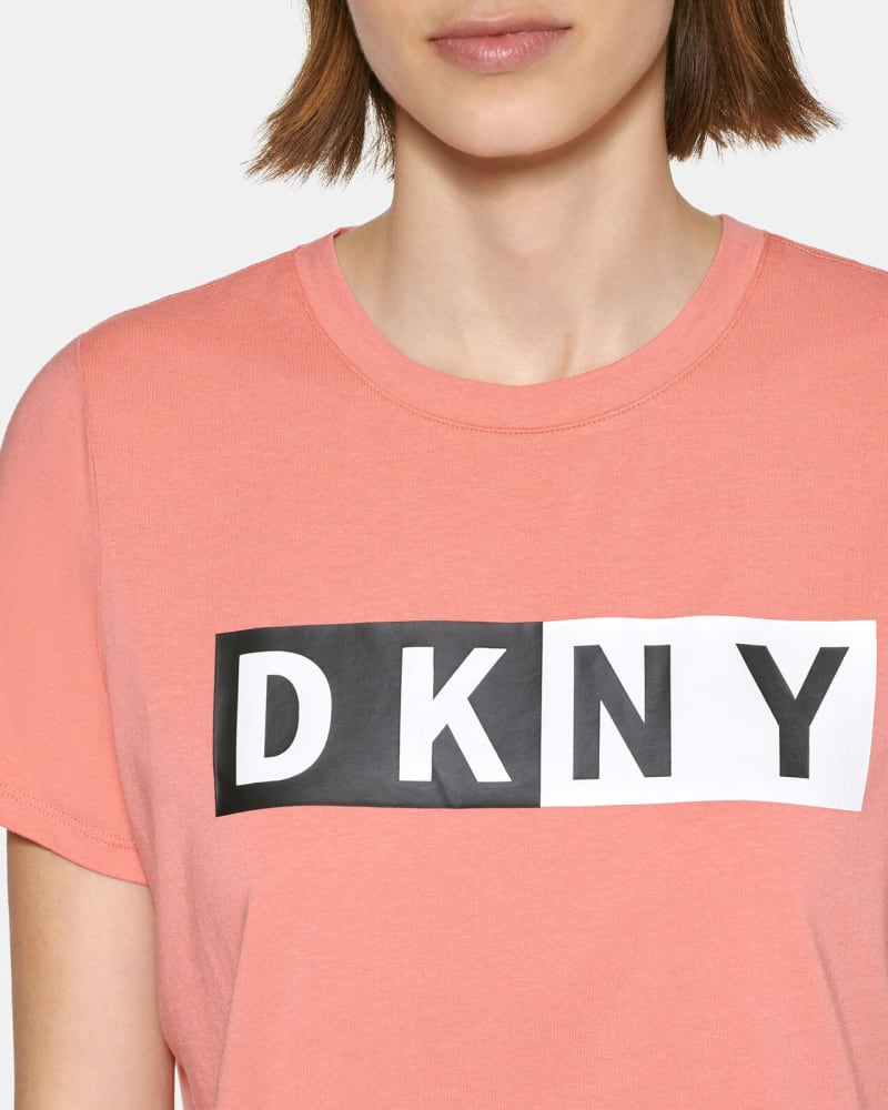 Front of a model wearing a size 1X DKNY Women's Plus Size Two-Tone Logo-Graphic T-Shirt Red Size 1X in Red by DKNY. | dia_product_style_image_id:314729